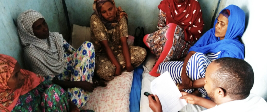 Health extension worker sitting with clients and having a discussion.